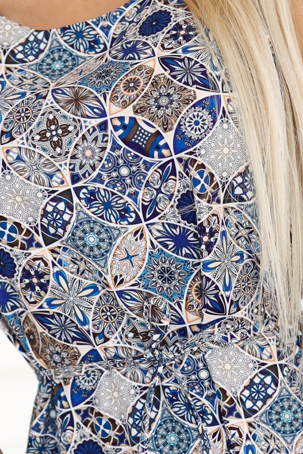 Modelka w letniej sukience marki Numoco z geometrycznym wzorem w odcieniach niebieskiego, beżu i brązu – idealna na wakacje, spacer, spotkanie z przyjaciółmi lub wyjście do miasta. Produkt polski.