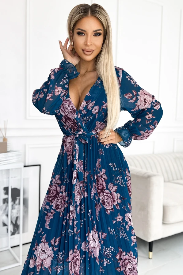 Plisowana szyfonowa sukienka w kwiaty prezentuje się elegancko i stylowo, idealna na wyjątkowe okazje. Sukienka plisowana szyfonowa ma głęboki dekolt i długie rękawy, co dodaje jej klasy i kobiecości.